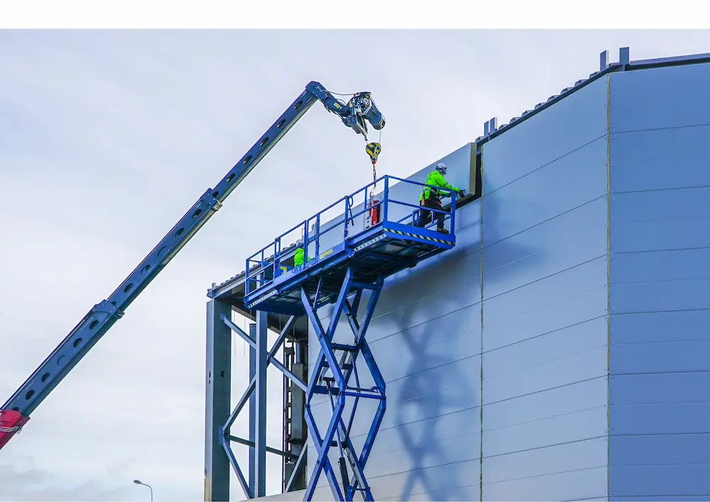 Engineers working on installing sandwich panels on construction site